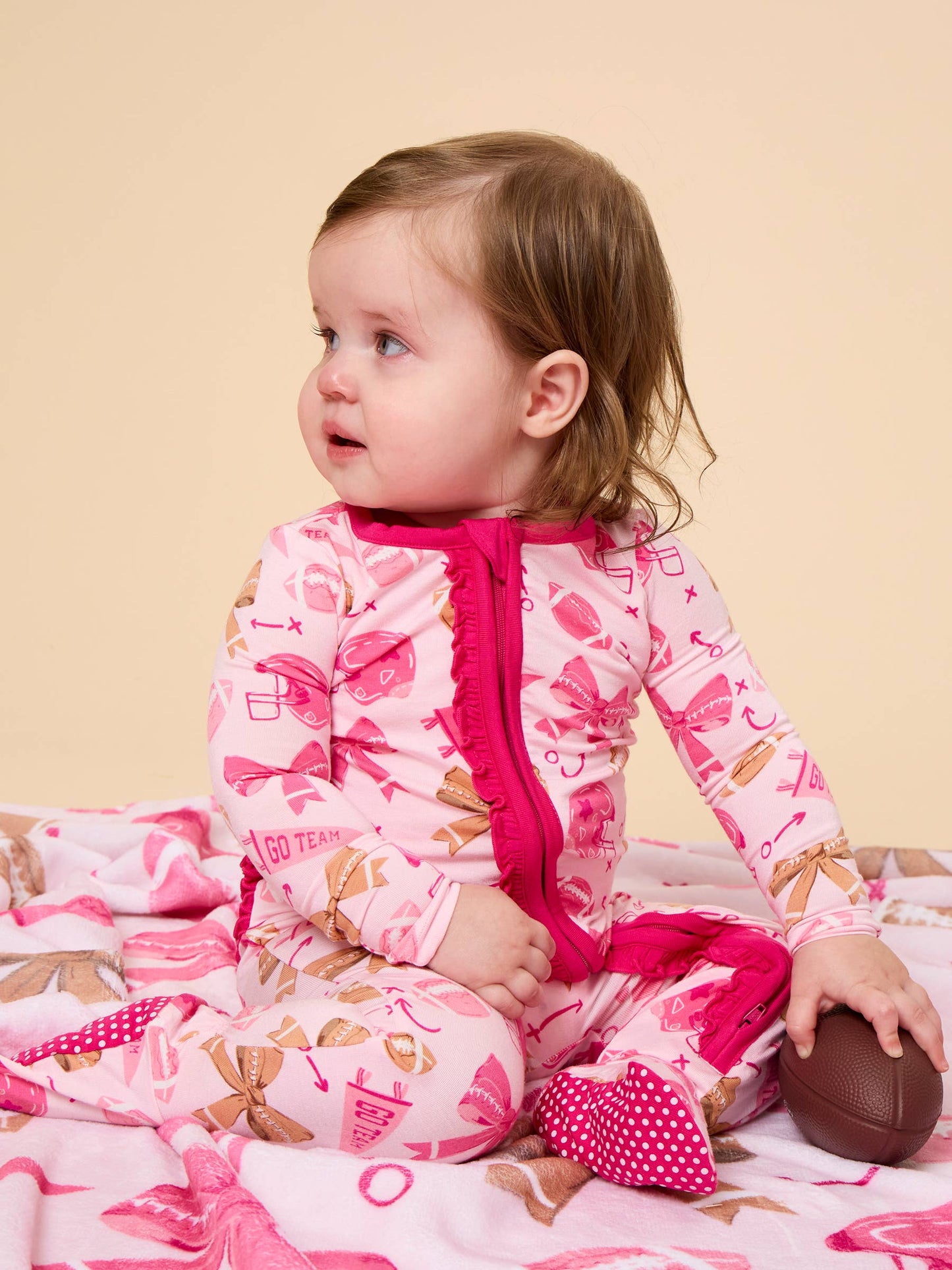 SoftSnooze™ Baby Girls Bamboo Viscose Footballs & Bows Footed Ruffle One Piece Pajama