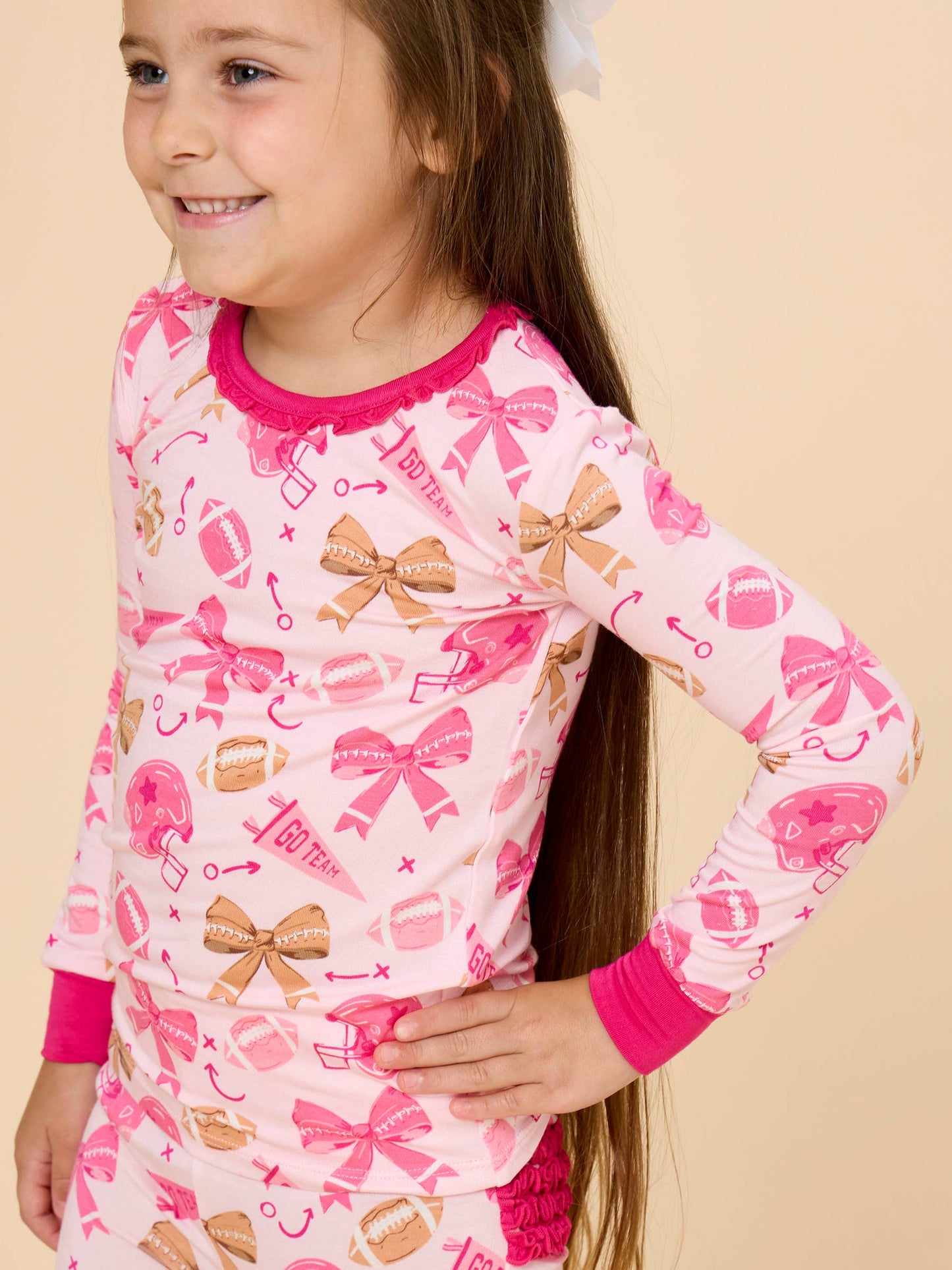 SoftSnooze™ Toddler Girls Bamboo Viscose Footballs & Bows Ruffle Long Sleeve Pajama Set with Signature Rear Ruffles