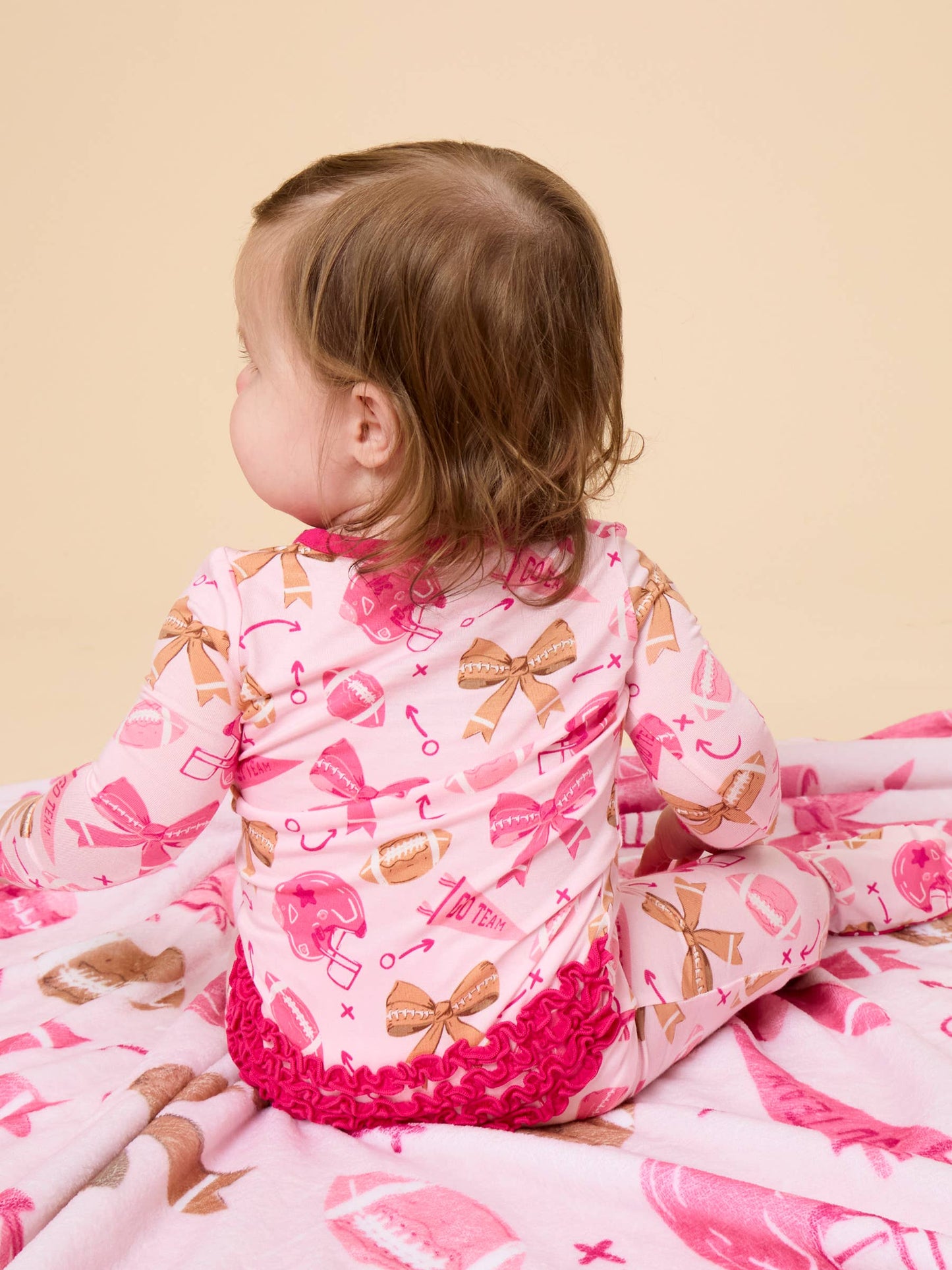 SoftSnooze™ Baby Girls Bamboo Viscose Footballs & Bows Footed Ruffle One Piece Pajama
