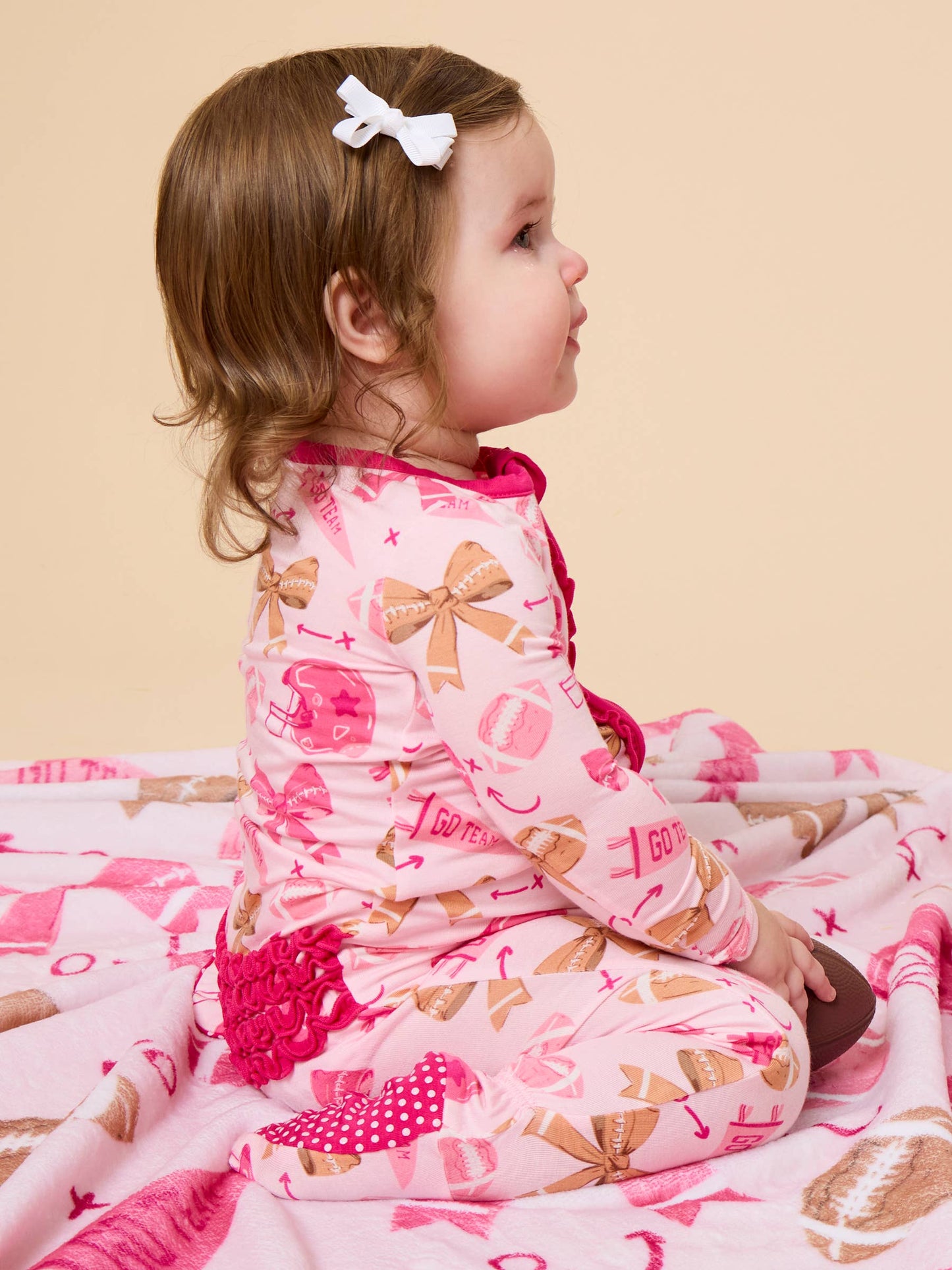 SoftSnooze™ Baby Girls Bamboo Viscose Footballs & Bows Footed Ruffle One Piece Pajama