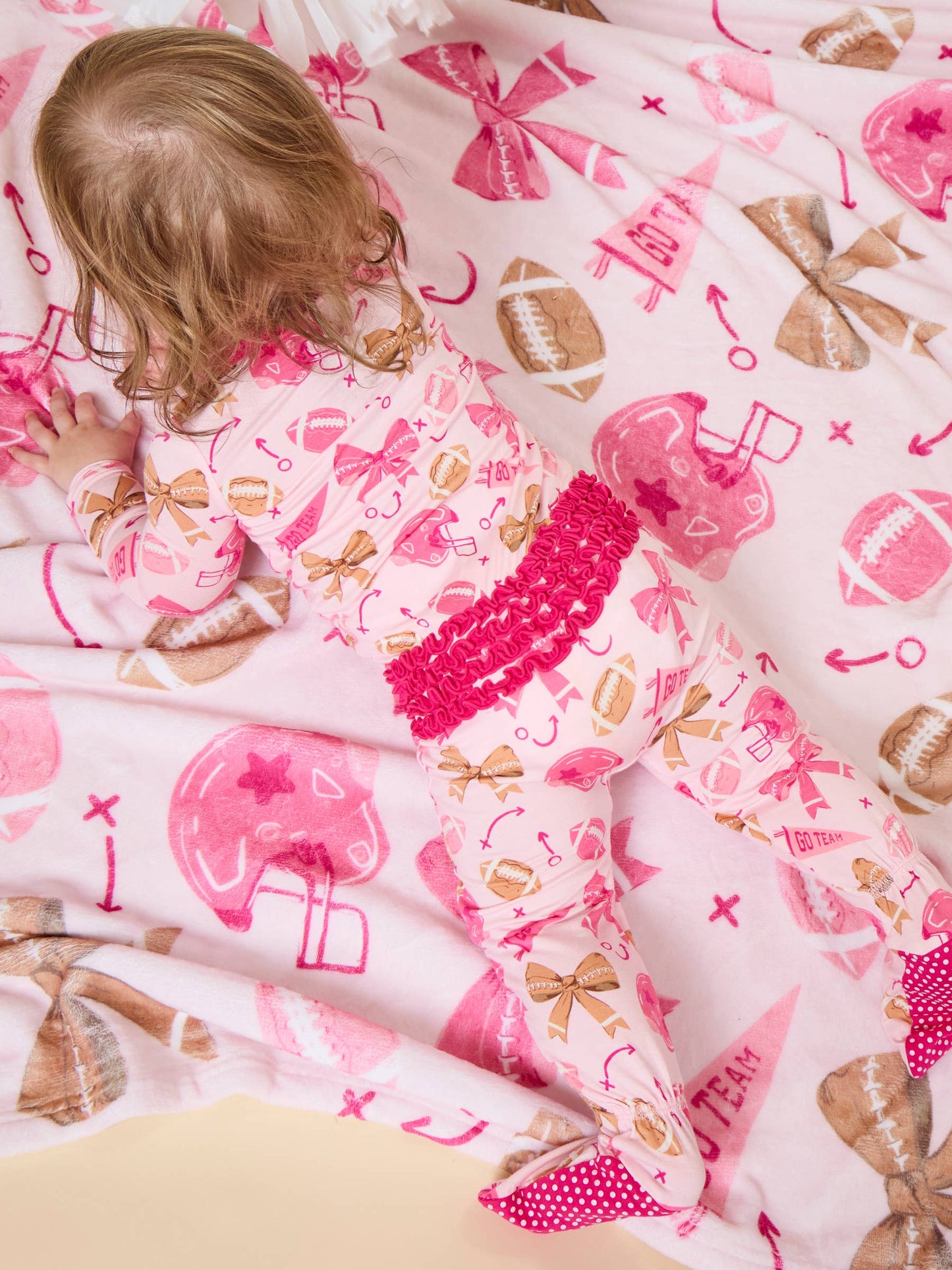 SoftSnooze™ Baby Girls Bamboo Viscose Footballs & Bows Footed Ruffle One Piece Pajama